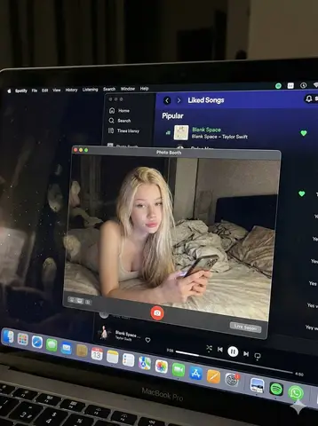 Экран MacBook с окном Photo Booth и открытым приложением Spotify.
